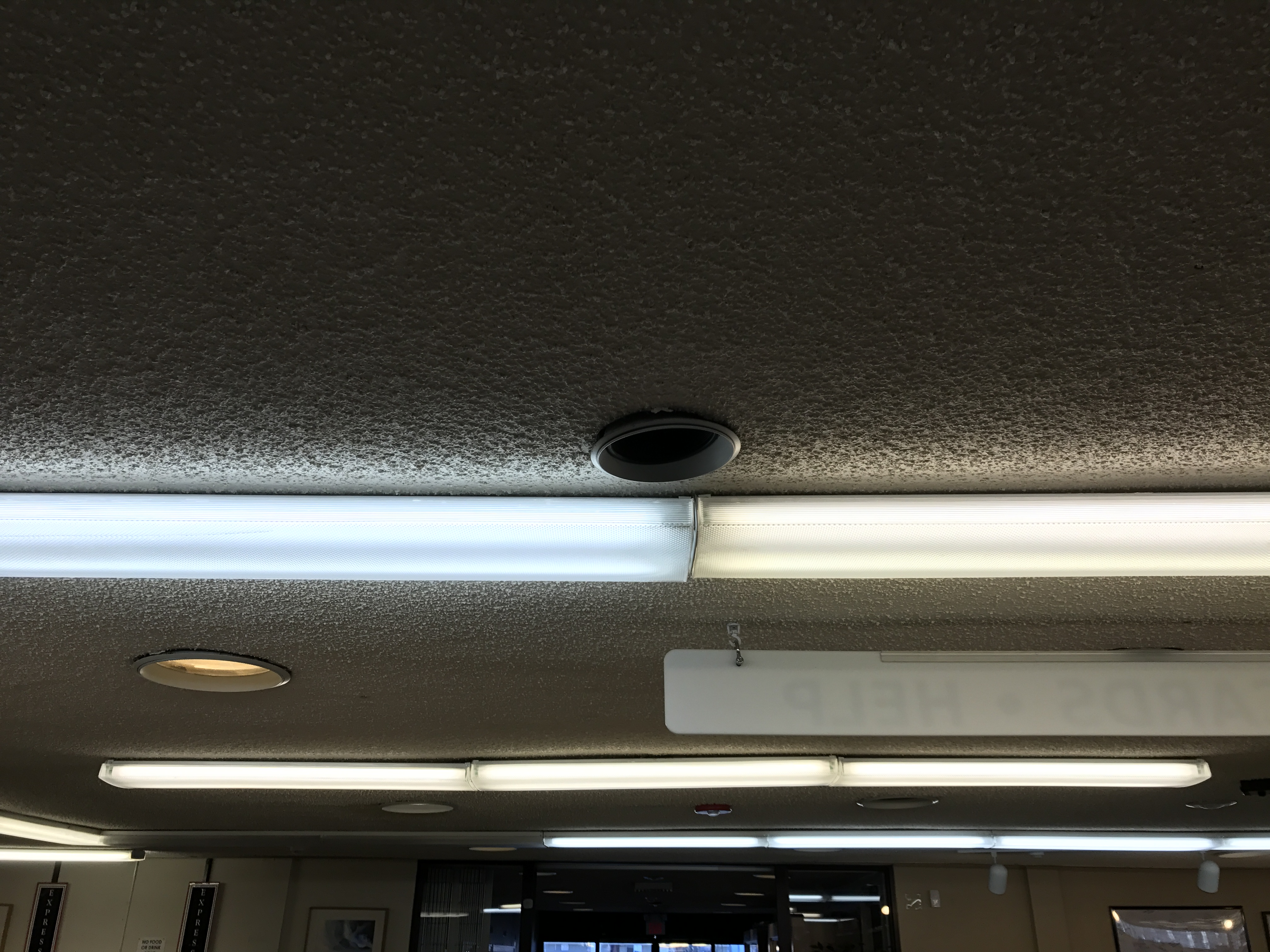 Carson City Public Library received new energy efficient lights during a recent performance contracting project. This picture shows the library’s first newly installed energy efficient light (top left) next to less efficient incandescence lights.
